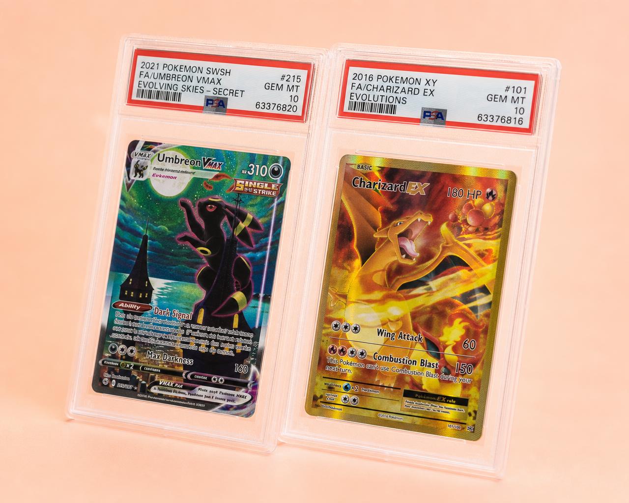 Two protective trading card cases on a pale lilac surface